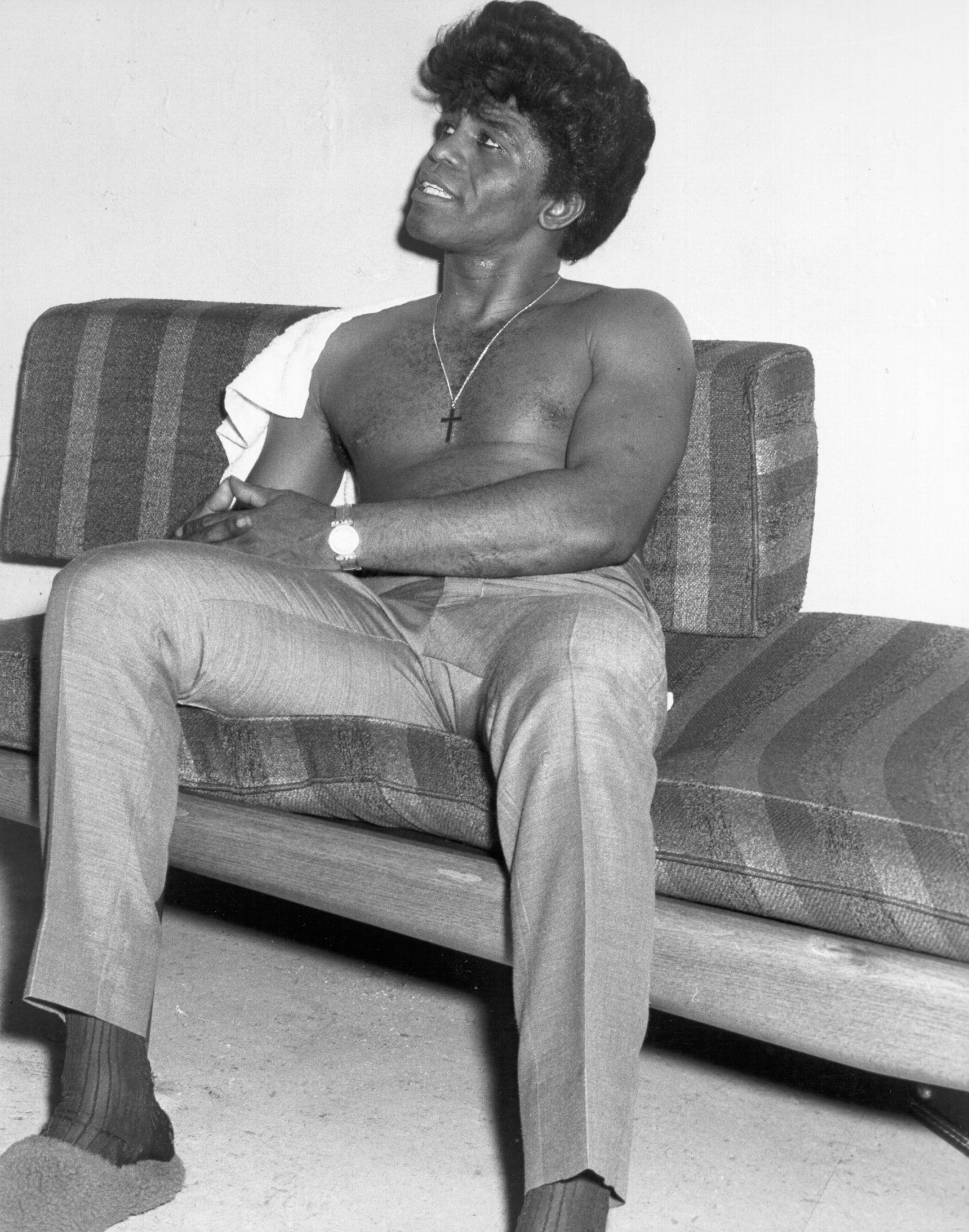 James Brown, shirt off and slippers on, backstage at his second home, the Apollo, 1964. Photo by Don Paulsen via Michael Ochs Archives/Getty Images.